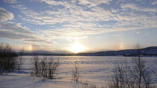 Koskullskulle – Tromsø Rechts und links sind weitere Lichtbrechungen (Nebensonnen) der Sonne (in der Mitte) zu sehen